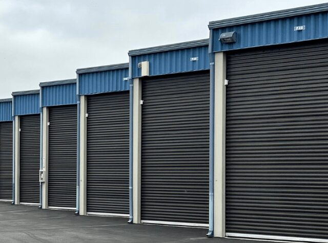 Row of closed storage unit roll-up doors