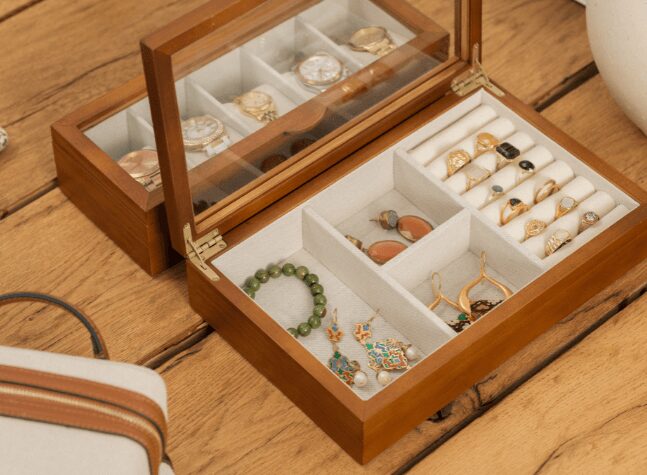 Elegant wooden jewelry box with rings, bracelets, and earrings neatly organized.
