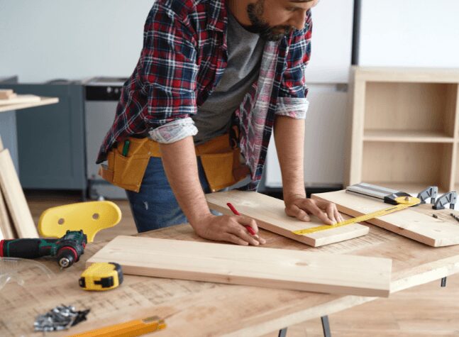 guy building on a wood work station